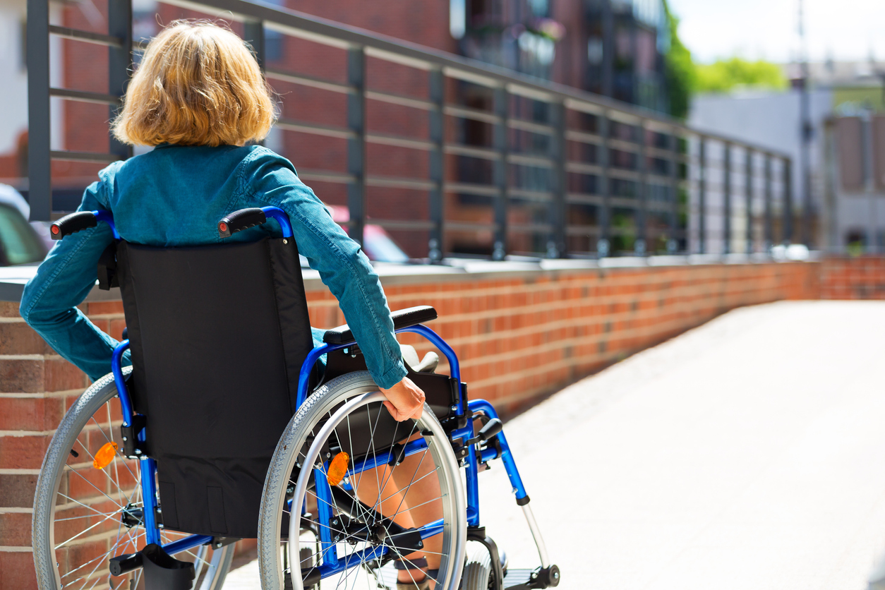 woman on wheelchair entering the platform parking lot maintenance