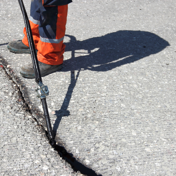 Sealing joint - crack in asphalt seal coat asphalt maintenance