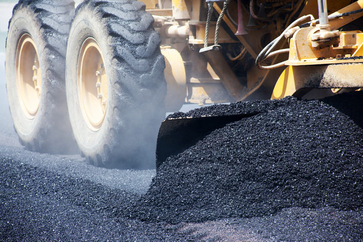 Asphalt being laid in a parking lot. Learn the asphalt paving dos and don'ts here!